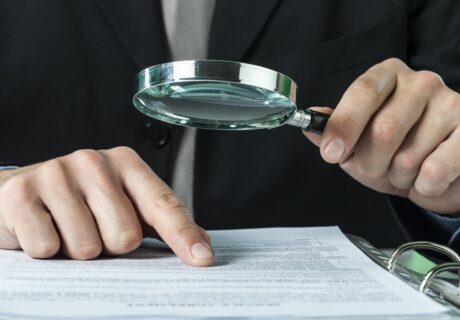 auditor examining files for employer workers' compensation fraud